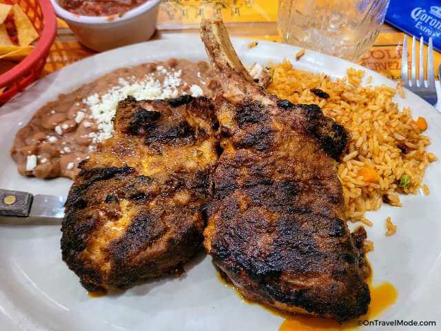 Chipotle pork chops with rice and refried beans