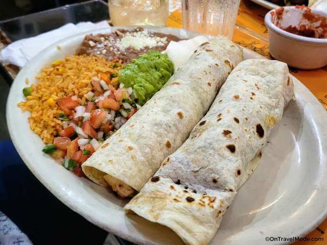 Chicken and steak burritos with rice and refried beans entree